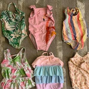 Infant girl one piece bathing suits, (6) total.